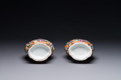 A pair of Chinese Canton famille rose 'mandarin subject' vases with floral relief design, Qianlong