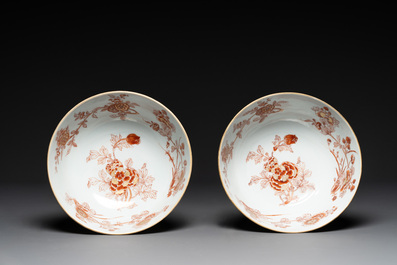 A pair of Chinese iron-red-decorated and gilt bowls with relief design, Kangxi