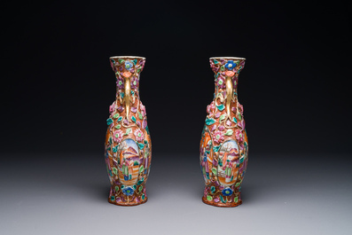 A pair of Chinese Canton famille rose 'mandarin subject' vases with floral relief design, Qianlong