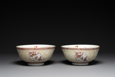 A pair of Chinese iron-red-decorated and gilt bowls with relief design, Kangxi