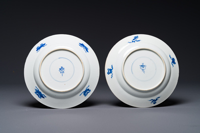 A pair of Chinese blue and white 'Buddhist lion' plates, ding mark, Kangxi