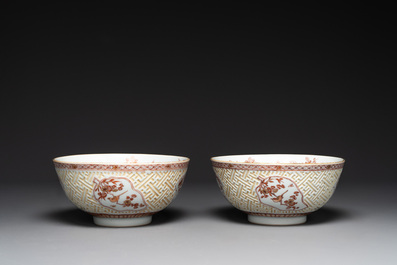 A pair of Chinese iron-red-decorated and gilt bowls with relief design, Kangxi