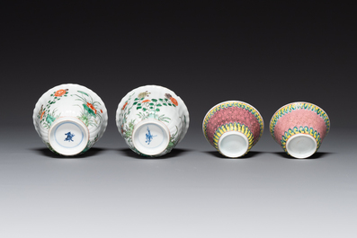 A pair of Chinese famille verte and a pair of famille rose cups and saucers, Kangxi/Yongzheng