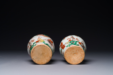 A pair of small Chinese wucai jars with figures in a landscape, Transitional period