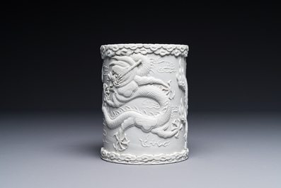 A Chinese monochrome white-glazed biscuit brush pot, signed Wang Bingrong 王炳榮, 19/20th C.