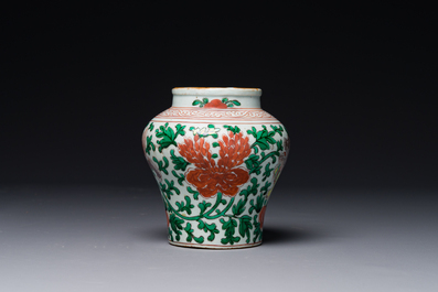 A small Chinese wucai 'Buddhist lion and peony scroll' jar, Transitional period