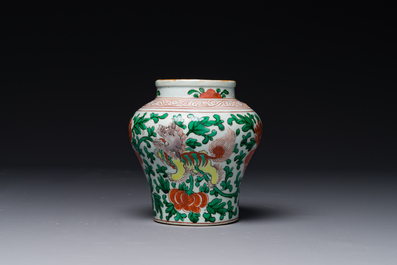 A small Chinese wucai 'Buddhist lion and peony scroll' jar, Transitional period