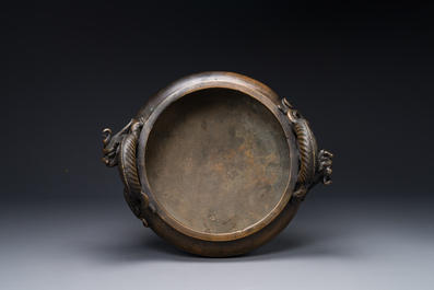 A large Chinese bronze tripod censer with 'chilong' handles, Qing Qian Gong 清乾宮 mark, 18th C.