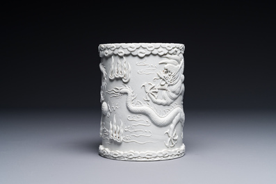 A Chinese monochrome white-glazed biscuit brush pot, signed Wang Bingrong 王炳榮, 19/20th C.