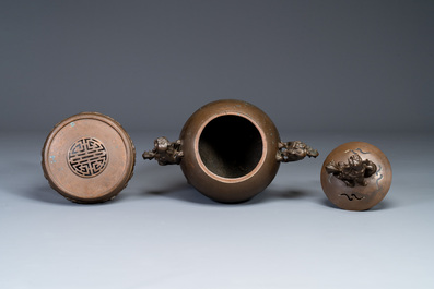 A large Chinese bronze censer and cover on stand decorated with six lions, 19th C.