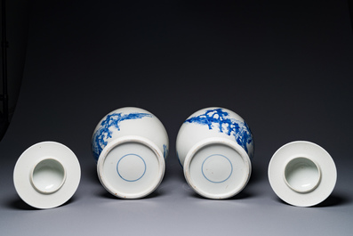 A pair of Chinese blue and white covered vases with figural design, 19th C.