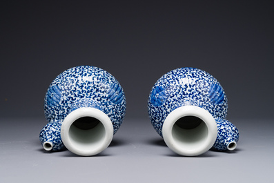 A pair of Chinese blue and white 'lotus scroll' kendis, 19th C.