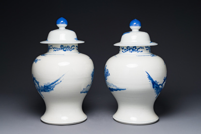 A pair of Chinese blue and white covered vases with figural design, 19th C.