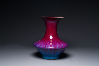 A Chinese flamb&eacute;-glazed vase on a wooden stand, 19th C.