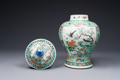 A pair of Chinese famille verte 'bird and flower' vases and covers, Kangxi mark, 19th C.