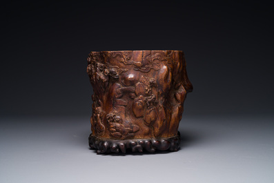 A large Chinese carved huanghuali wooden brush pot with Taoist design, 17/18th C.