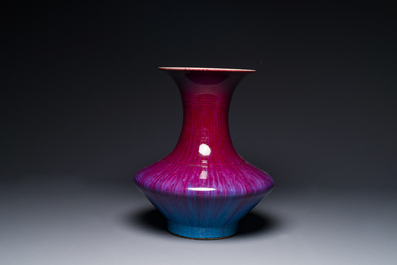 A Chinese flamb&eacute;-glazed vase on a wooden stand, 19th C.