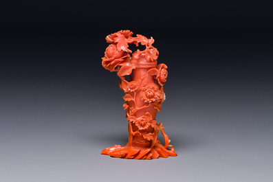 A Chinese red coral sculpture of a vase and cover with peonies, 19/20th C.