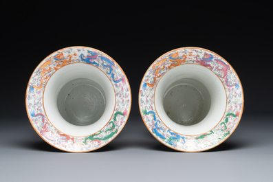 A pair of Chinese Canton famille rose spittoons with dragons, birds, butterflies and flowers, 19th C.