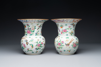 A pair of Chinese Canton famille rose spittoons with dragons, birds, butterflies and flowers, 19th C.