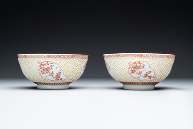 A pair of Chinese iron-red-decorated and gilt bowls with relief design, Kangxi