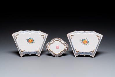 A pair of fine Chinese Canton enamel cups and three saucers with floral design, Yongzheng/Qianlong