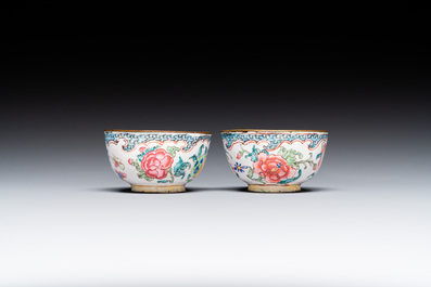 A pair of fine Chinese Canton enamel cups and three saucers with floral design, Yongzheng/Qianlong