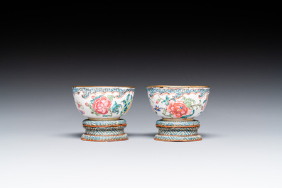 A pair of fine Chinese Canton enamel cups and three saucers with floral design, Yongzheng/Qianlong