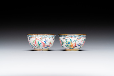 A pair of fine Chinese Canton enamel cups and three saucers with floral design, Yongzheng/Qianlong