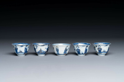 Thirteen Chinese blue and white saucers and twelve cups with figural design, Kangxi/Yongzheng