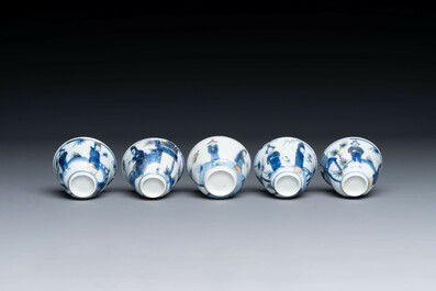 Thirteen Chinese blue and white saucers and twelve cups with figural design, Kangxi/Yongzheng