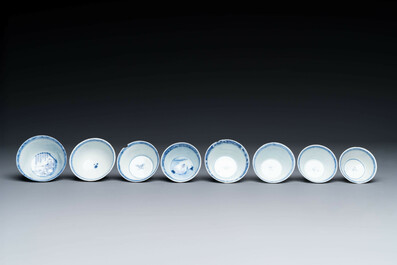 Thirteen Chinese blue and white saucers and twelve cups with figural design, Kangxi/Yongzheng