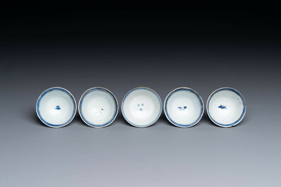 Thirteen Chinese blue and white saucers and twelve cups with figural design, Kangxi/Yongzheng