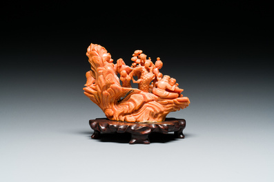 A Chinese red coral 'Eight Immortals' group on wooden stand, 19/20th C.