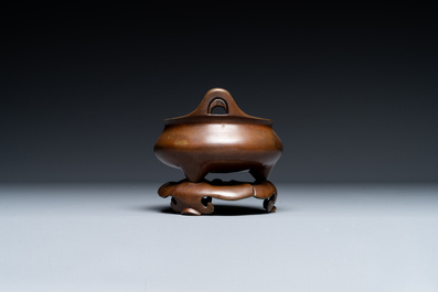 A Chinese bronze tripod censer on a stand, Xuande mark, 19th C.