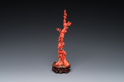 A Chinese red coral sculpture of Xiwangmu standing on a rock, 19/20th C.