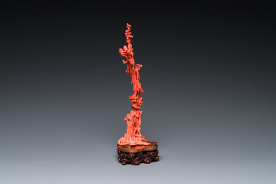 A Chinese red coral sculpture of Xiwangmu standing on a rock, 19/20th C.