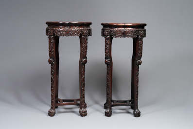 A pair of tall Chinese carved wooden stands with marble tops, 19th C.