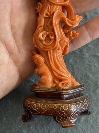 A Chinese red coral figure of a standing lady with a flower basket, 19/20th C.