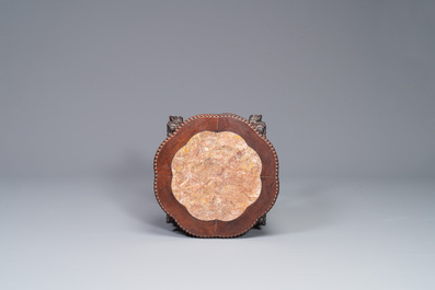 A Chinese carved wooden stand and a low table with marble tops, 19th C.