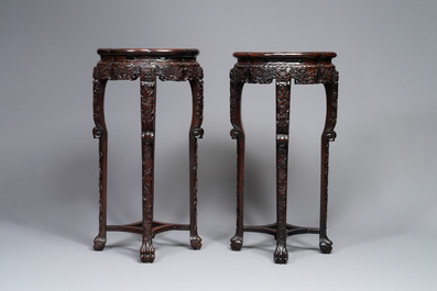 A pair of tall Chinese carved wooden stands with marble tops, 19th C.