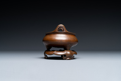 A Chinese bronze tripod censer on a stand, Xuande mark, 19th C.