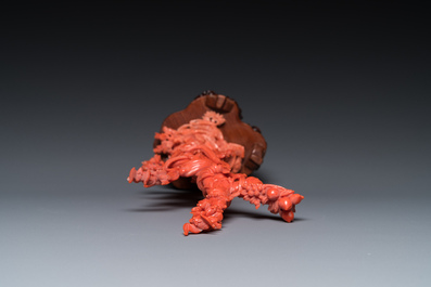 A Chinese red coral sculpture of Xiwangmu standing on a rock, 19/20th C.