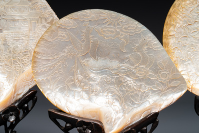 Five Chinese carved mother-of-pearl shells on wooden stands, Canton, 19th C.