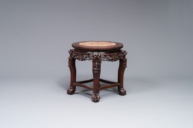 A Chinese carved wooden stand and a low table with marble tops, 19th C.