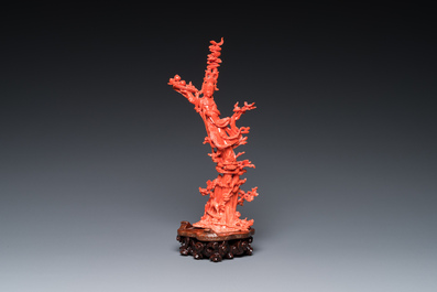 A Chinese red coral sculpture of Xiwangmu standing on a rock, 19/20th C.