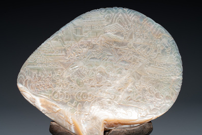 Five Chinese carved mother-of-pearl shells on wooden stands, Canton, 19th C.