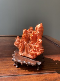 A Chinese red coral 'Eight Immortals' group on wooden stand, 19/20th C.