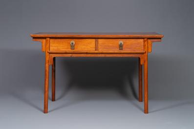 A Chinese huanghuali wooden two-drawer recessed-leg table, 19/20th C.