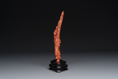 A Chinese red coral figure of a fisherman on wooden stand, 19/20th C.